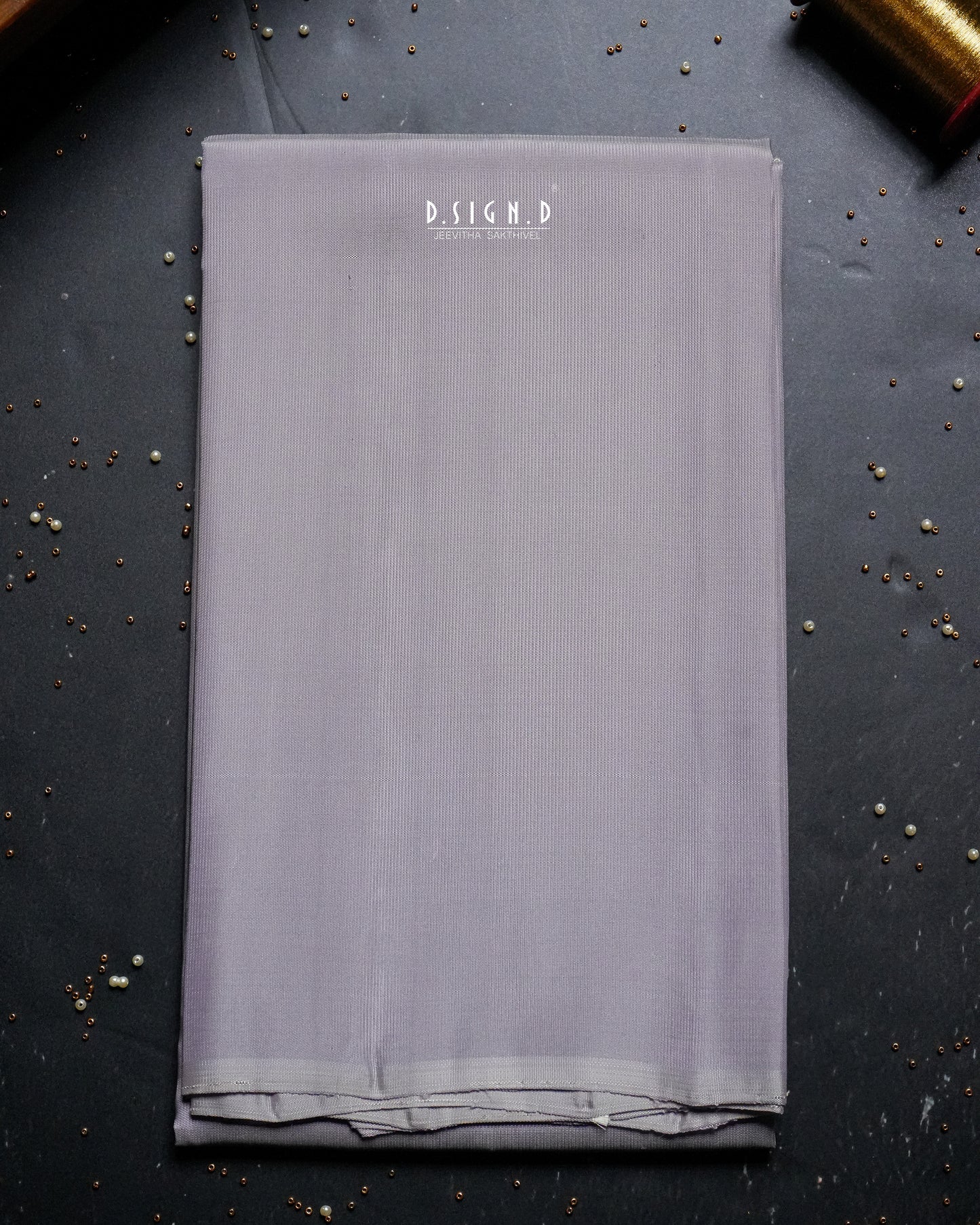 A folded piece of mauve shade shirt material.