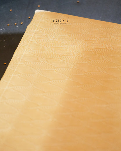A close-up of a silk fabric with an embossed repeating wave pattern, set against a dark textured background.