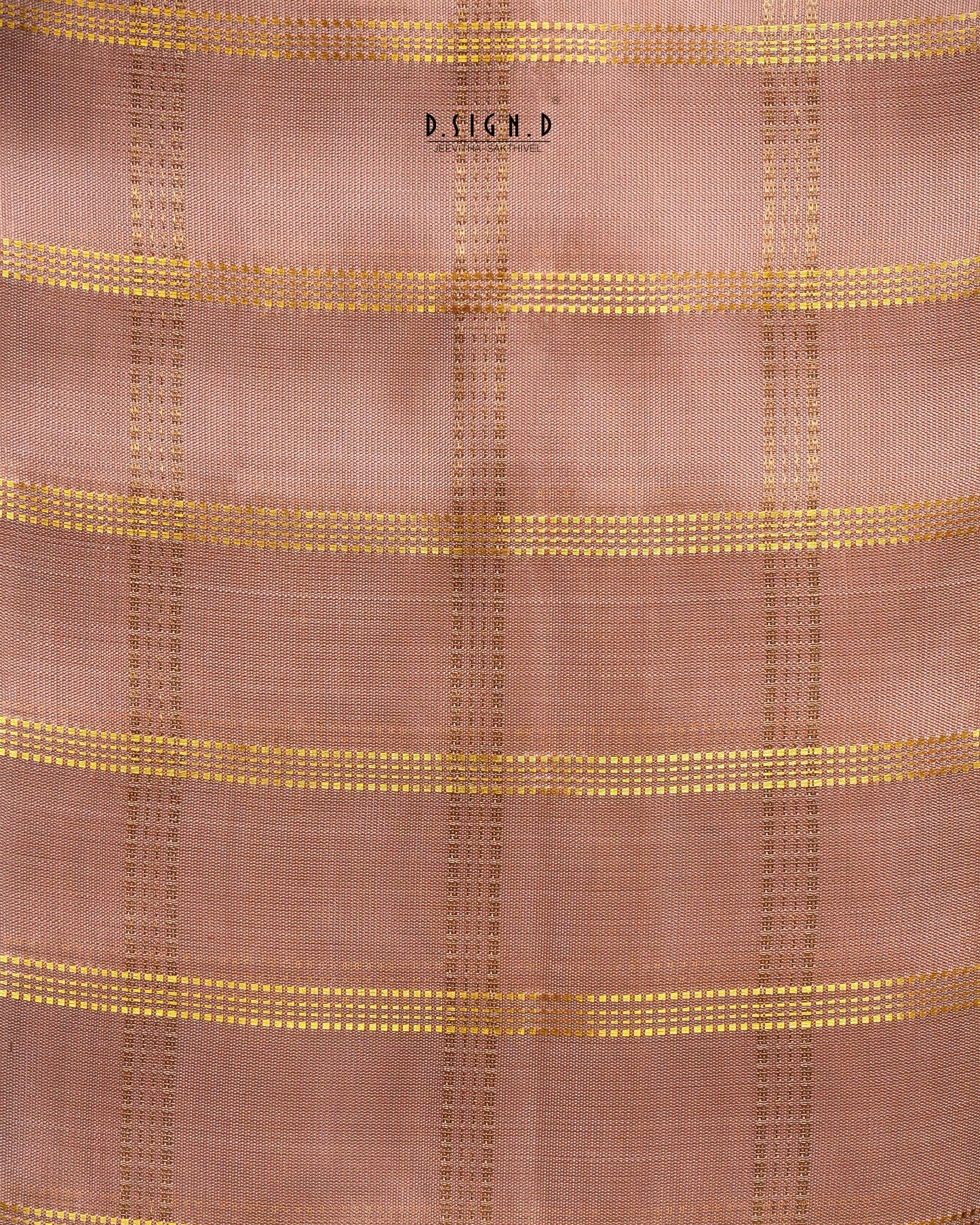 A close-up of a copper shade woven fabric with a subtle grid texture and horizontal metallic gold stripes.