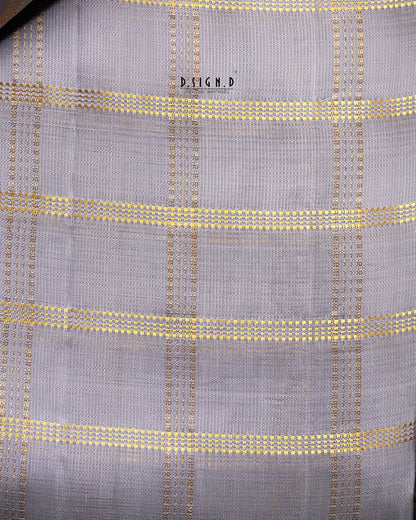 A close-up of a woven fabric with a mauve base and a gold checkered plaid pattern. 