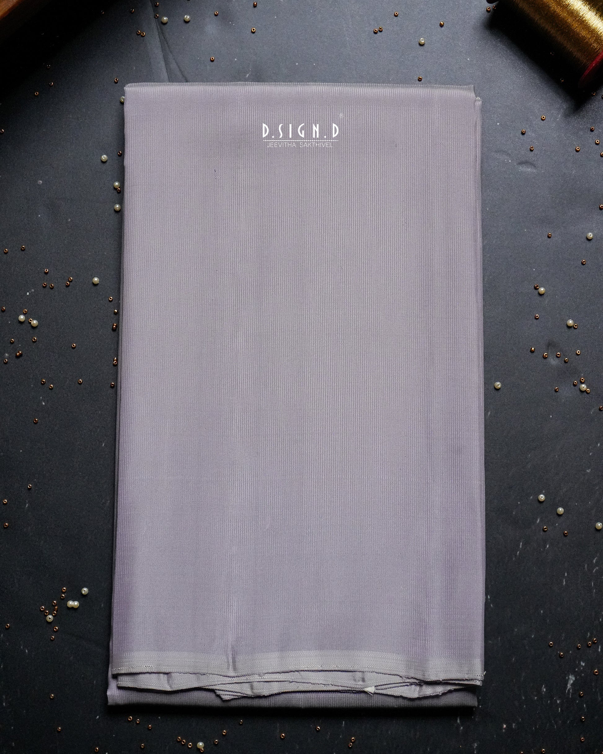 A folded piece of mauve shade shirt material. 
