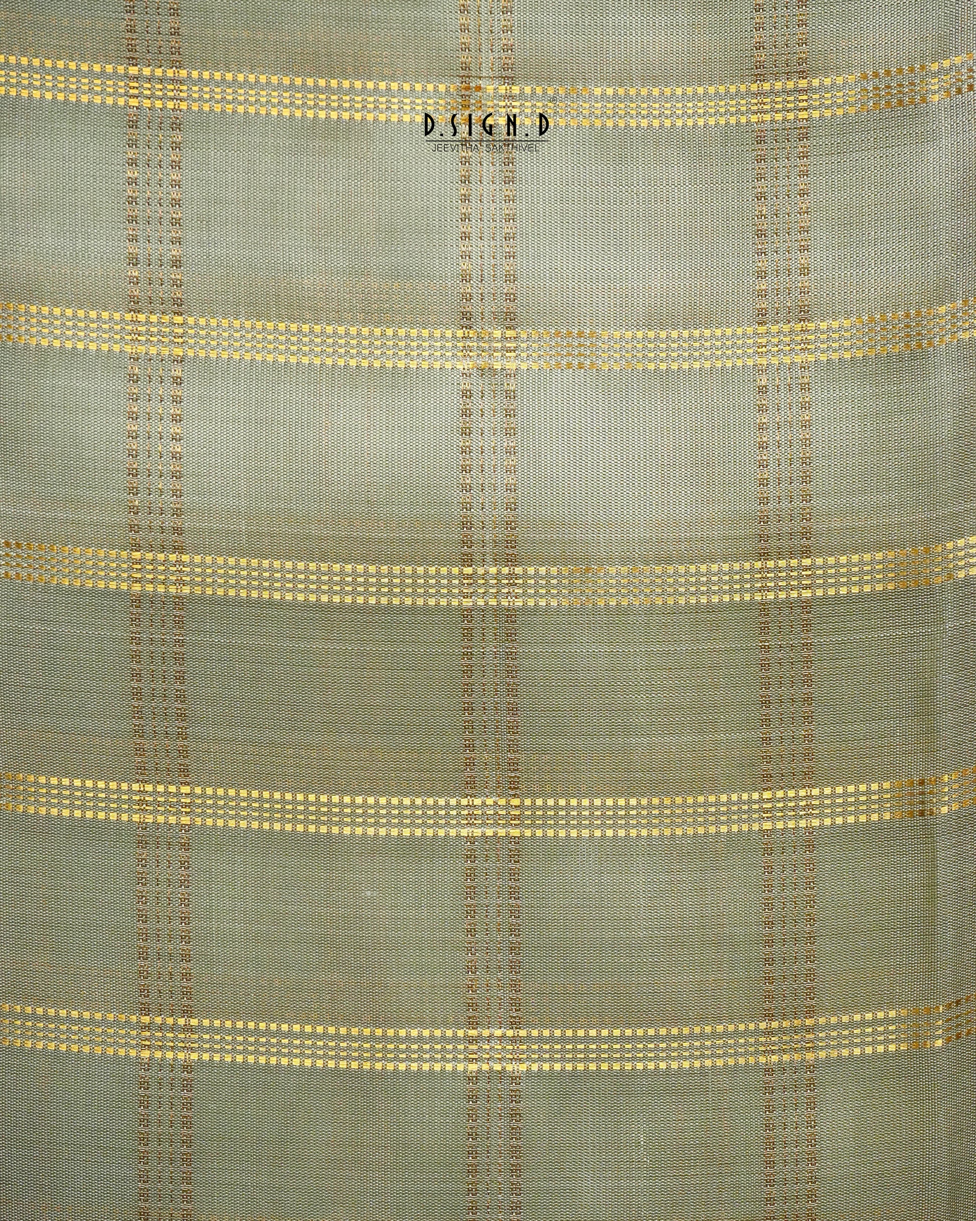 A close-up of a woven fabric with a muted pista green base and horizontal stripes of gold and brown woven dots.