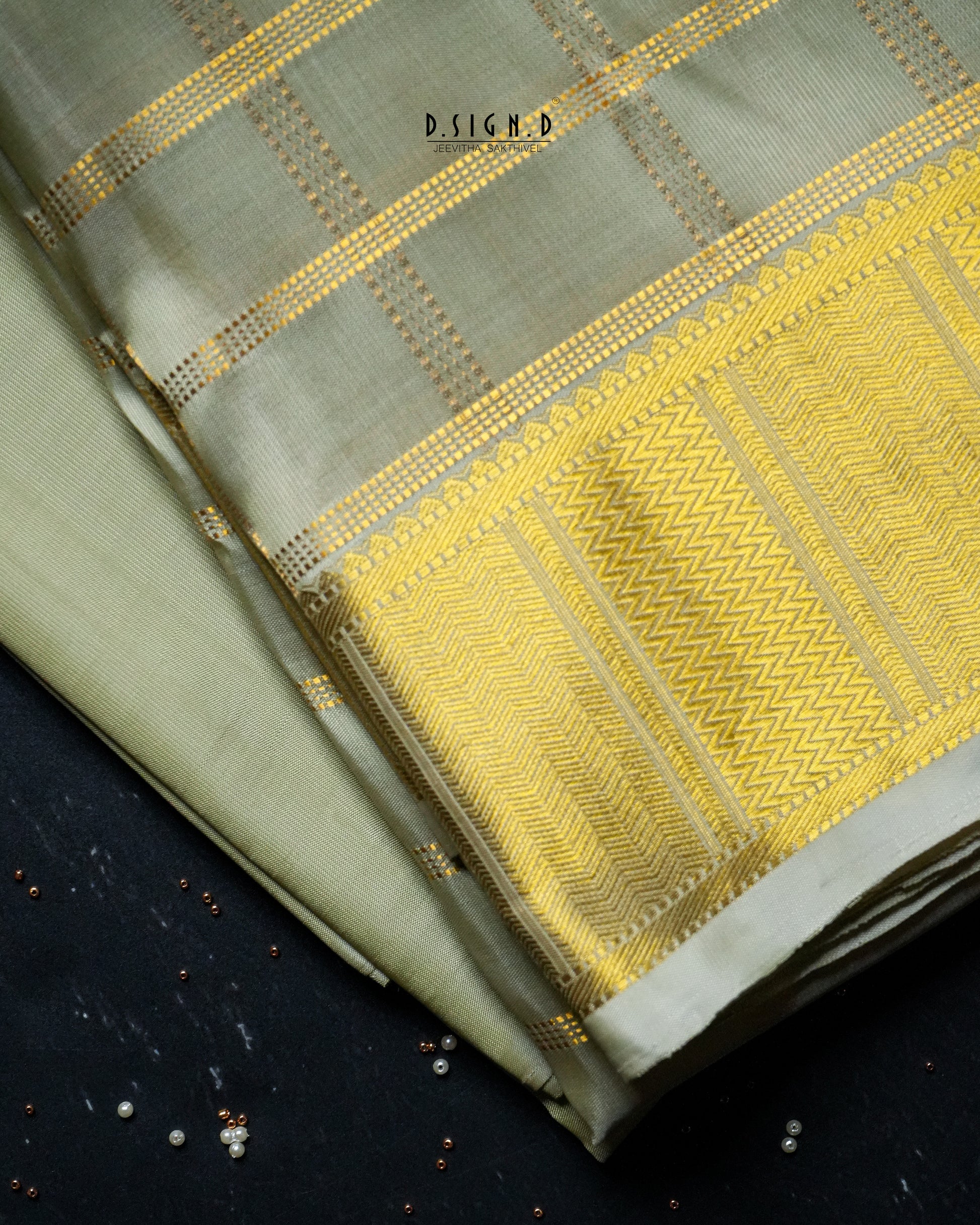 A folded pista green dhoti with a wide golden-yellow woven border & plain shirt material , displayed on a dark textured surface.