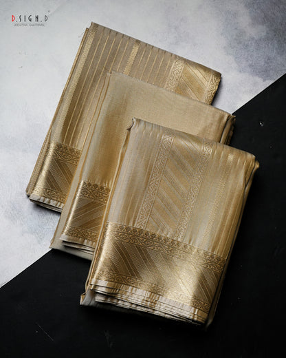 Three folded pieces of metallic gold fabric with woven geometric borders, arranged diagonally on a split light gray and black background. 