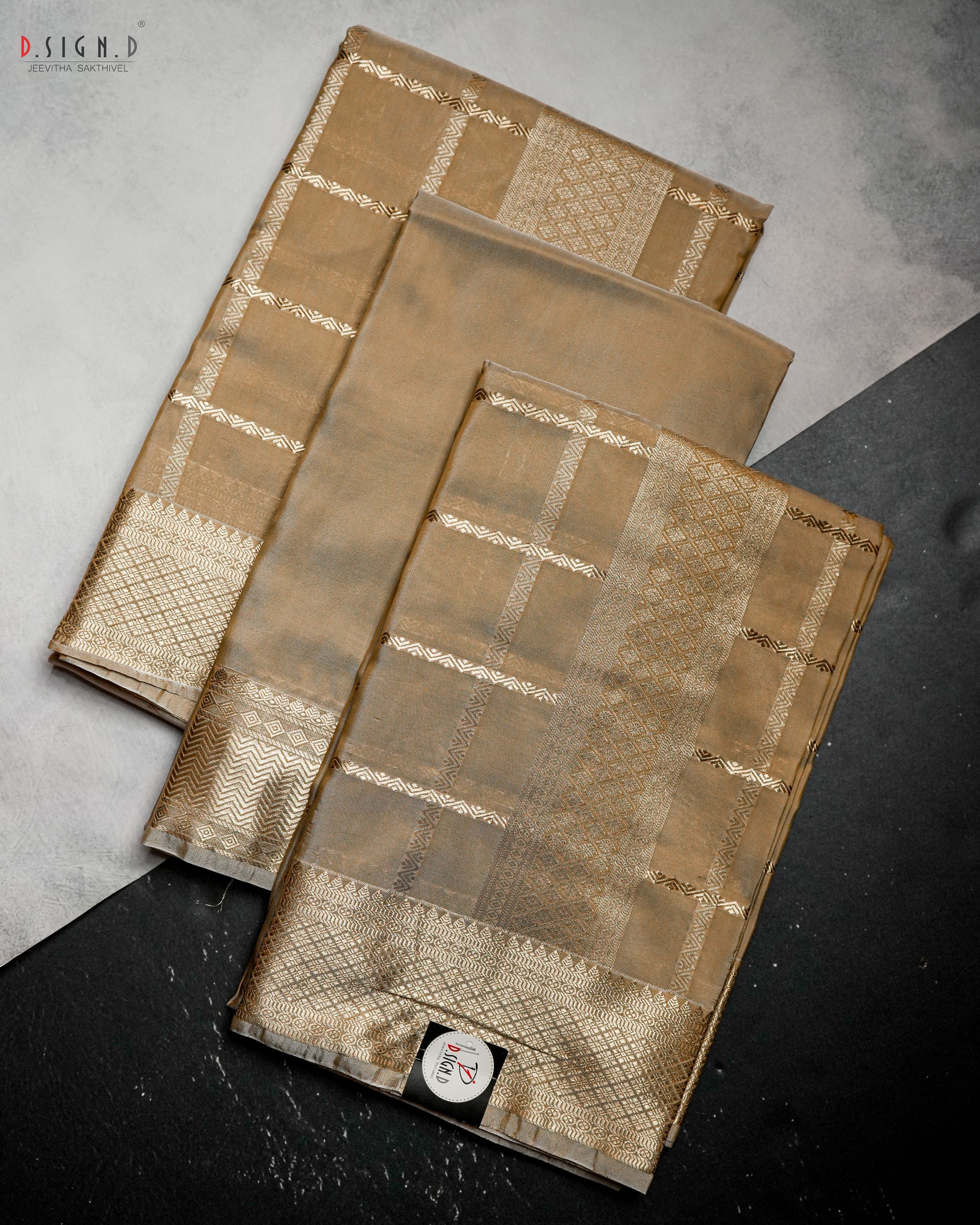 Dark gold Kattam fine silk dhoti set folded to highlight woven check pattern and ornate zari border