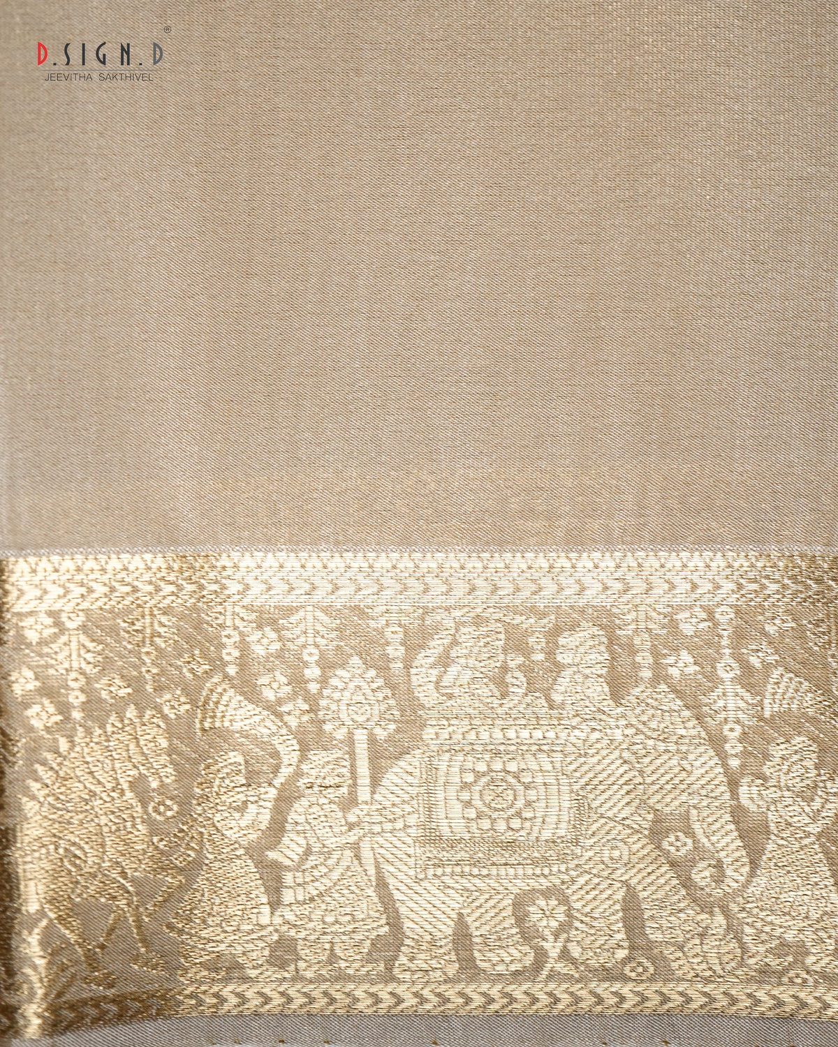 Beige silk dhoti shirt fabric with a wide gold zari border featuring traditional Indian motifs including an elephant and figures.