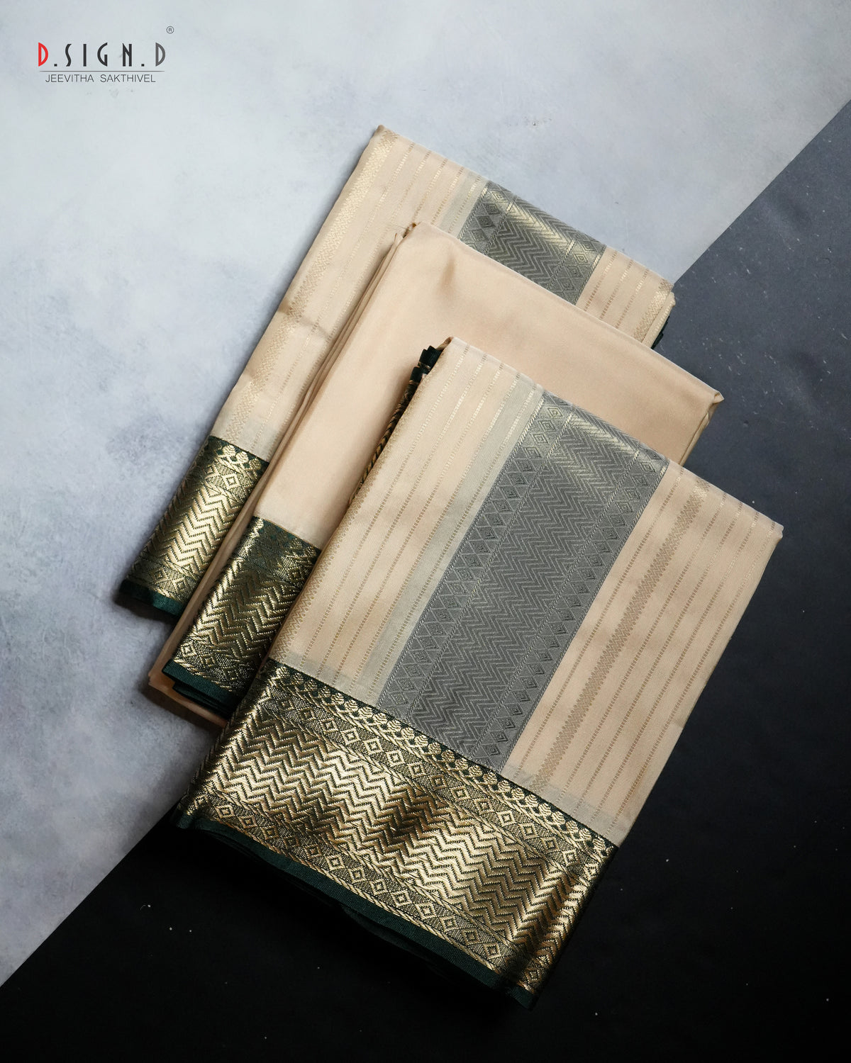 A folded beige and gold dhoti,vastram & shirt bit with a wide gold zari border, displayed on a split gray and black background. 