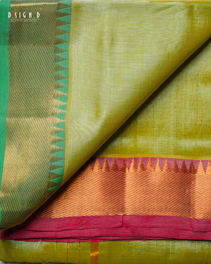 A folded and draped silk dhoti & vastram with a light olive green body, a green and gold patterned border, and a wide orange and magenta zari border.