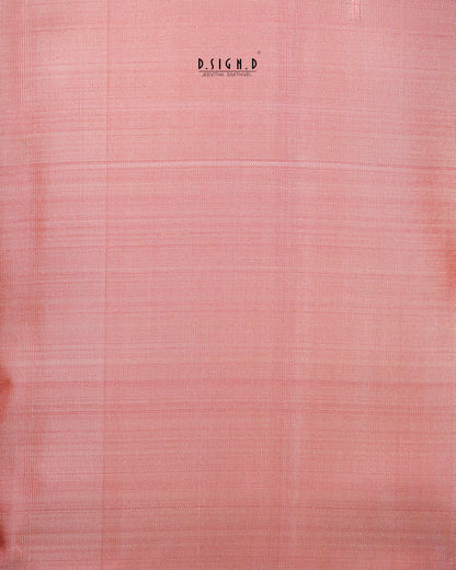 A close-up of a peach woven fabric with a subtle grid texture . 