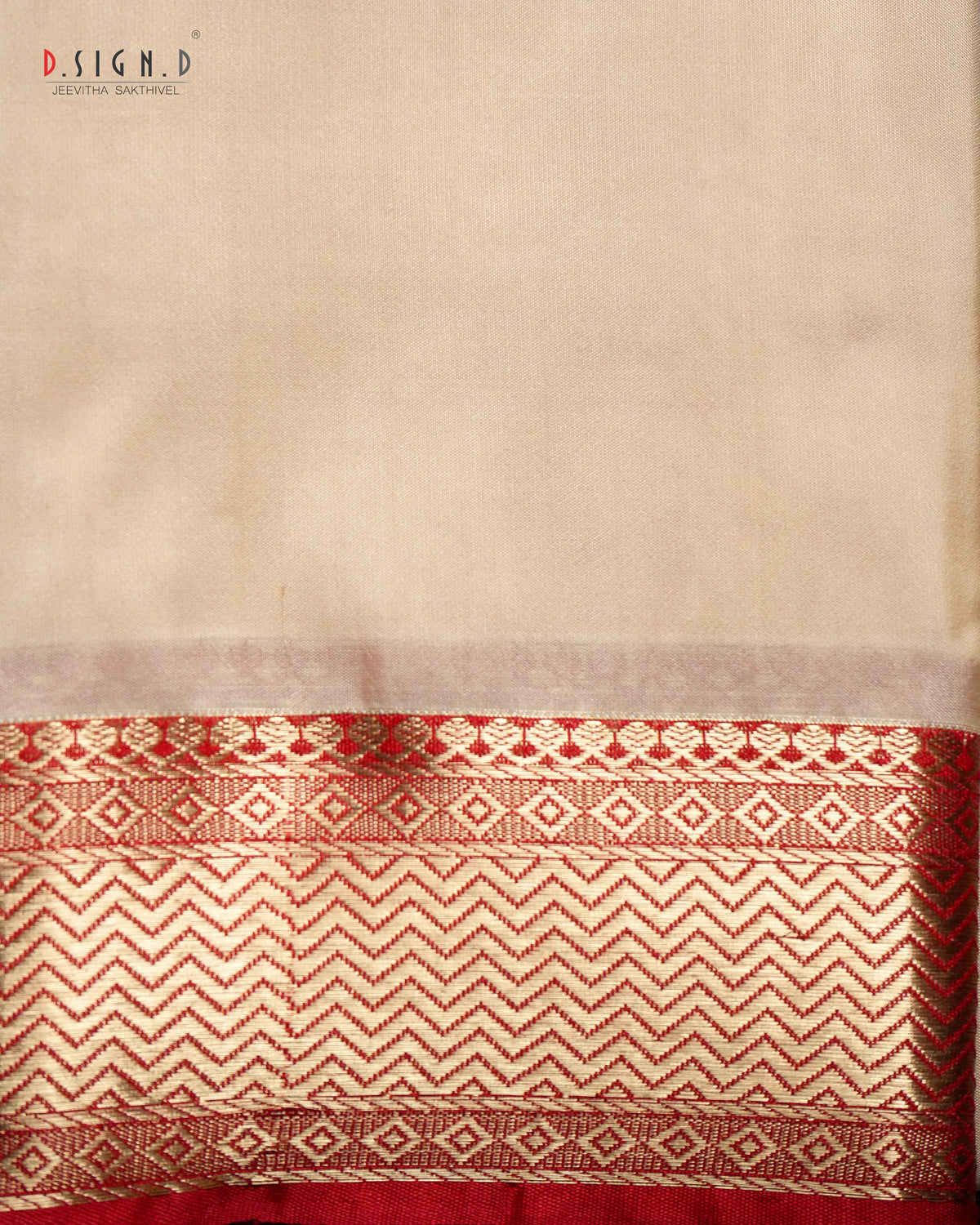 A close-up of a beige fabric (shirt bit ) with a wide decorative border at the bottom featuring red and beige woven geometric patterns. 