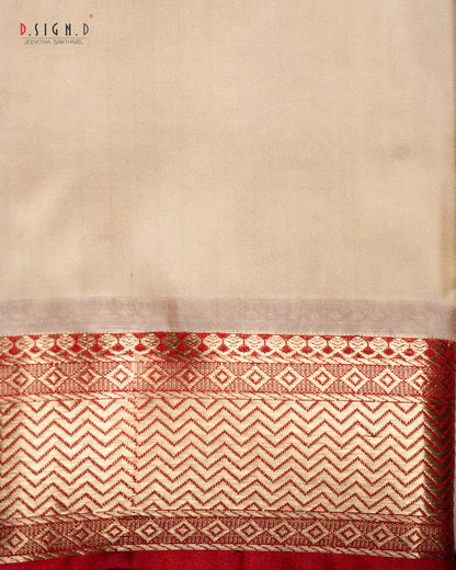 A close-up of a beige fabric (shirt bit ) with a wide decorative border at the bottom featuring red and beige woven geometric patterns. 