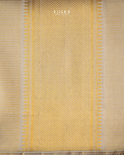 A close-up of a woven textile in pale  beige, showing a textured basketweave pattern with decorative vertical borders and fringe at the bottom. 
