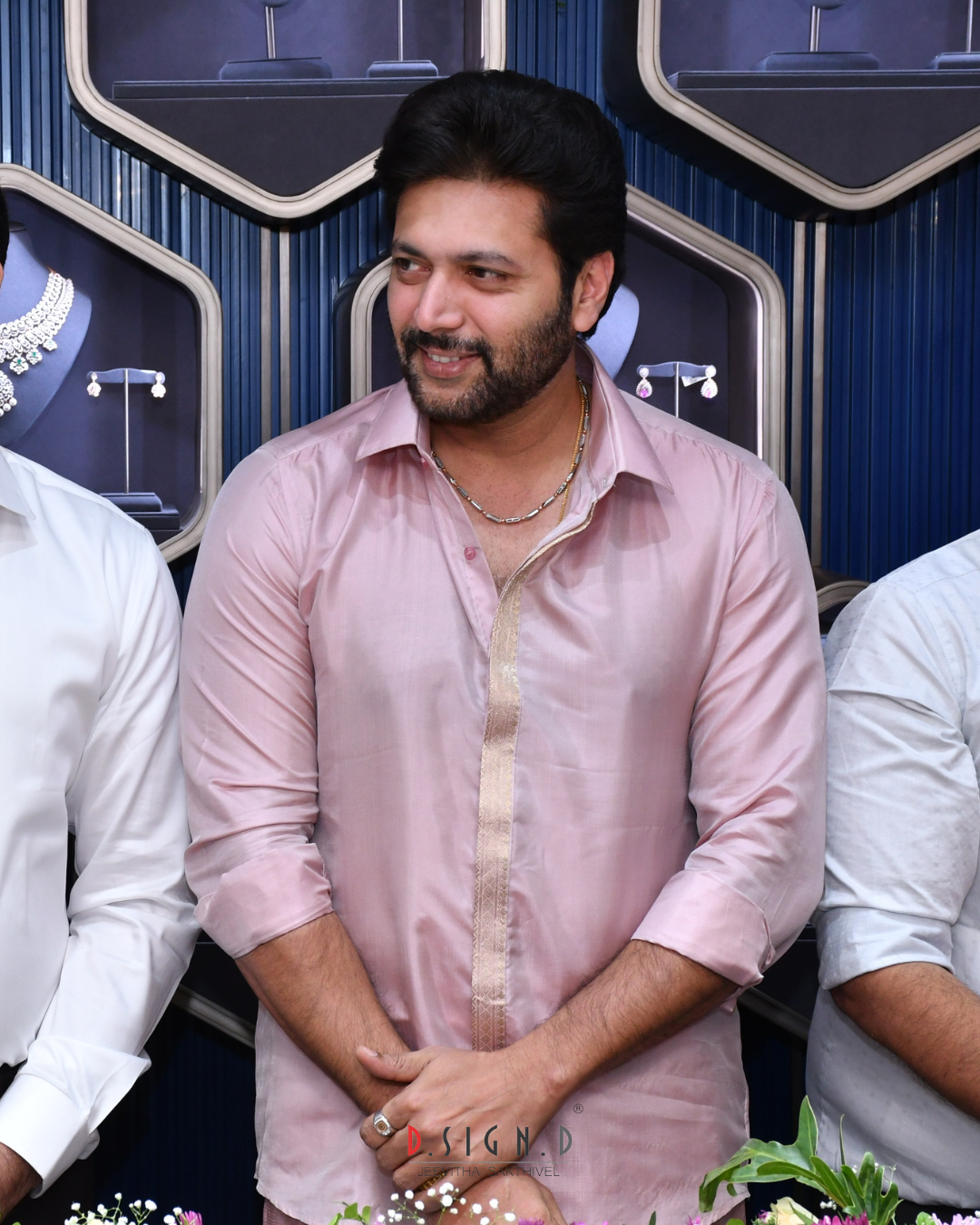 actore ravi mohan in bridal rose fine silk dhoti at an event with a blue and silver decorative background